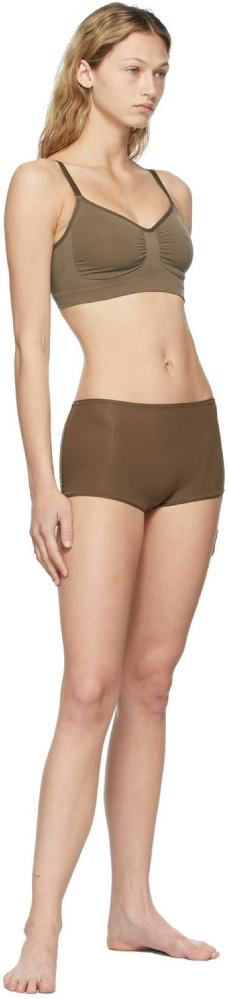 SSENSE's Post | Wearing: Skims Khaki Seamless Sculpting Bra In Oxide; Skims Brown Fits Everybody Boy Shorts In Oxide