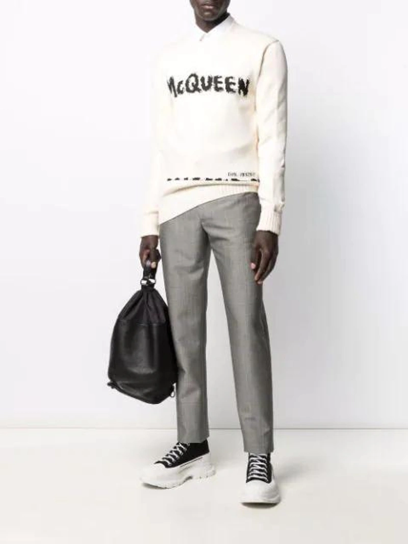 Farfetch's Post | Wearing: Dolce & Gabbana Dg Striped Jacquard Cotton Poplin Shirt In White; Alexander Mcqueen Tread Slick Canvas High-top Trainers In Black; Alexander Mcqueen Graffiti Intarsia-knit Jumper In Neutral