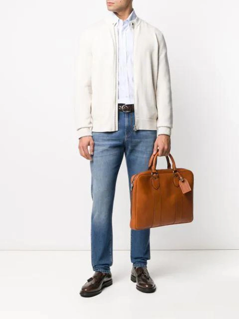 Farfetch's Post | Wearing: Brunello Cucinelli Directional Stripe Shirt In Blue; Brunello Cucinelli Straight Leg Jeans In Blue; Brunello Cucinelli Grained-effect Briefcase In Brown