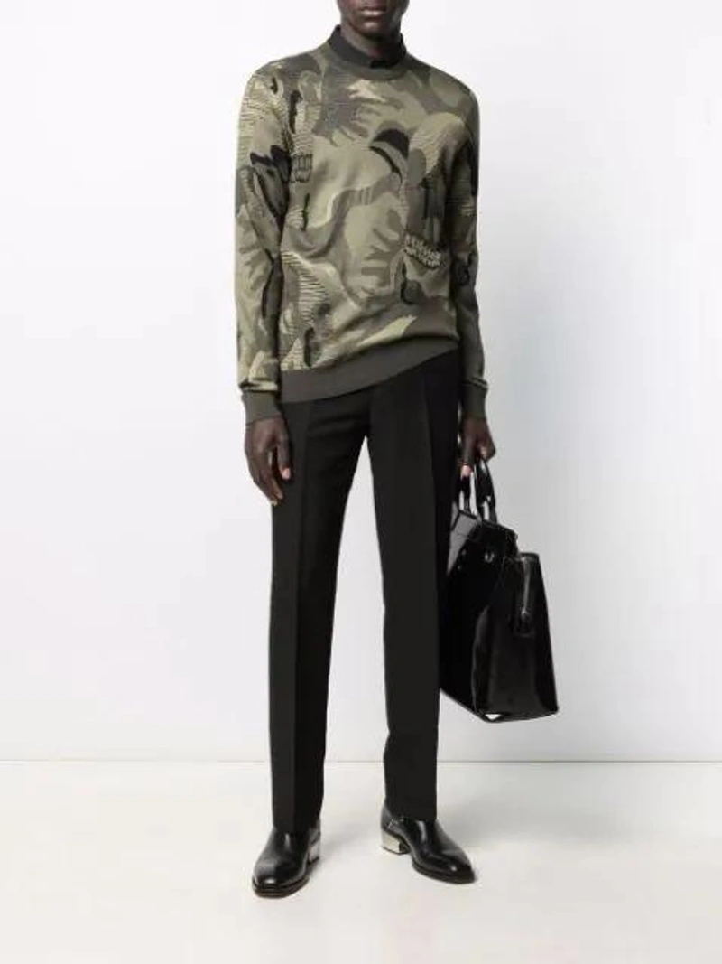 Farfetch's Post | Wearing: Alexander Mcqueen Chunky High-top Trainers In Black; Alexander Mcqueen Skull-motif Camouflage-intarsia Jumper In Green; Ami Alexandre Mattiussi Pleated Carrot Fit Trousers In Black