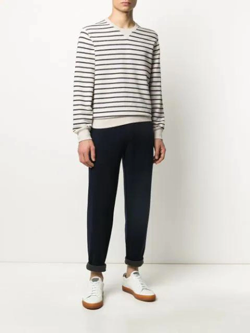 Farfetch's Post | Wearing: Brunello Cucinelli Pintucked Cashmere-blend Jersey Track Pants In Blue; Brunello Cucinelli Striped Mariner Sweatshirt In Neutrals