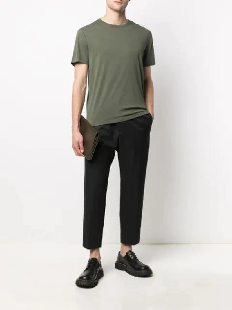 Farfetch's Post | Wearing: Jil Sander Wide-leg Tailored Trousers In Blue; Officine Generale Finished-edge Cotton T-shirt In Green; Ami Alexandre Mattiussi Large Accordion Bag In Green