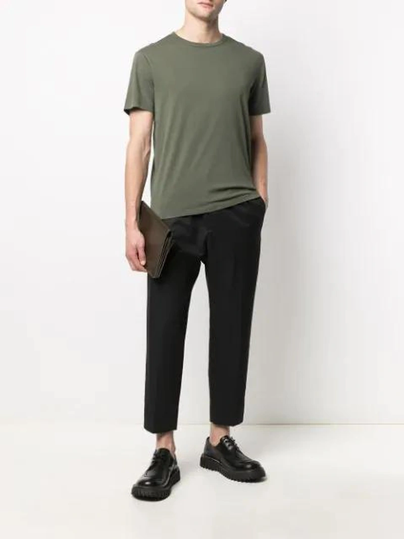 Farfetch's Post | Wearing: Officine Generale Finished-edge Cotton T-shirt In Green; Jil Sander Wide-leg Tailored Trousers In Blue; Ami Alexandre Mattiussi Large Accordion Bag In Green