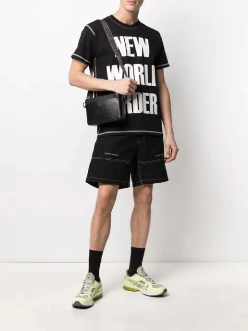 Farfetch's Post | Wearing: United Standard Shorts Plain With Contrasting Stitching In Nero; United Standard New World Order Tee In Nero; Off-white Men's Binder Clip Leather Camera Bag In Black