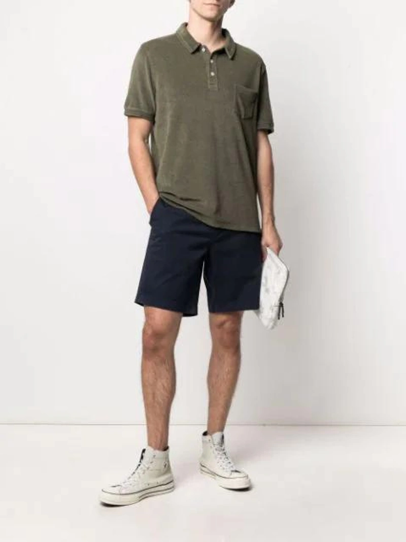 Farfetch's Post | Wearing: Closed Terrycloth-effect Polo-shirt In Green; Neighborhood X Porter Technical Nylon Pouch In White; Converse Chuck 70 Hi Mono Patchwork Sneakers In White