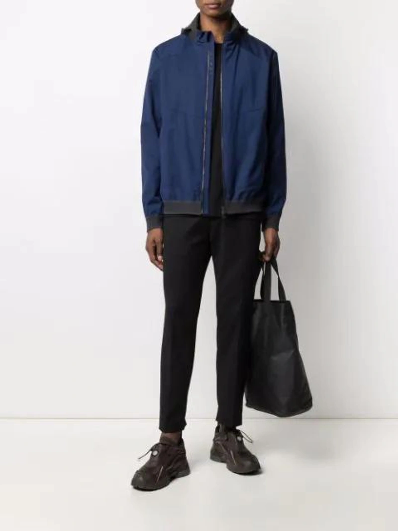 Farfetch's Post | Wearing: Sease Hooded Front Zip Jacket In Blue; Cmmn Swdn Tapered Drawstring Trousers In Black; Arc'teryx Granville Waterproof Tote Bag In Black