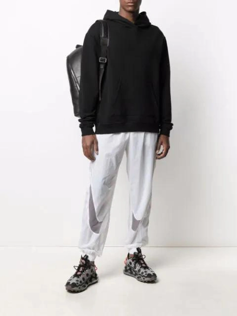 Farfetch's Post | Wearing: Nike Logo Mesh-panel Track Pants In White; John Elliott Basic Cotton Hooded Sweatshirt In Black; Calvin Klein Round Backpack In Black
