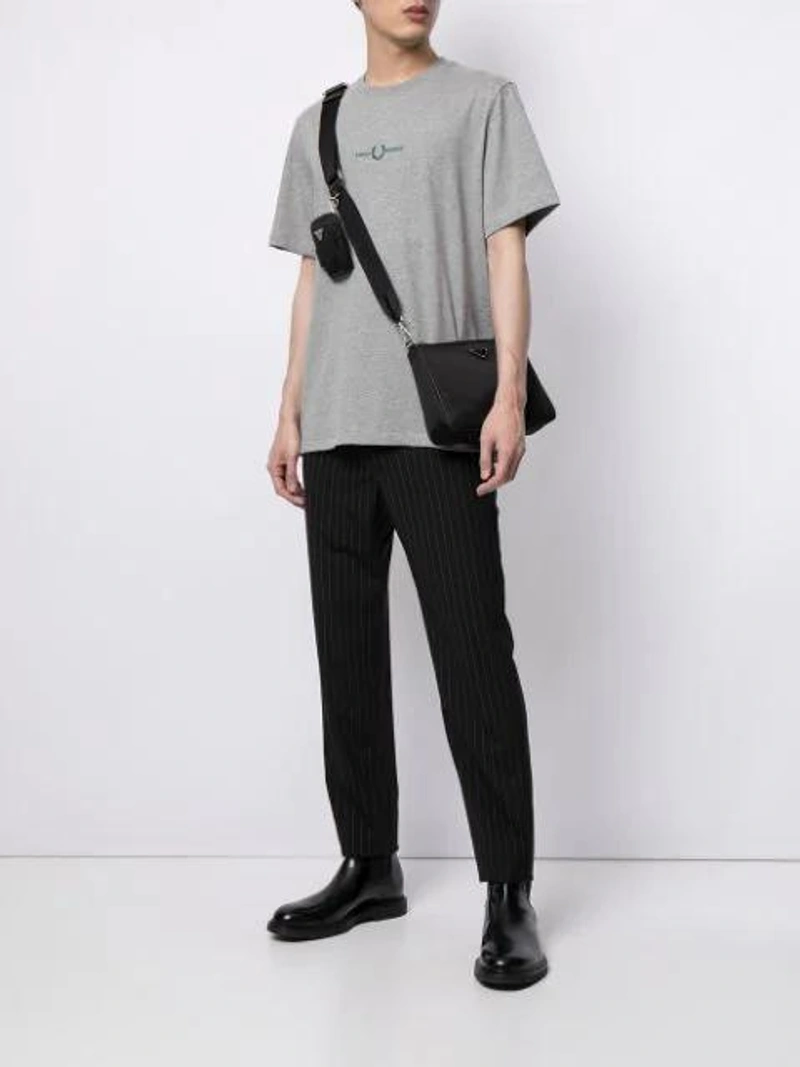Farfetch's Post | Wearing: Fred Perry Logo-printed T-shirt In Grey; Paul Smith Tapered Tailored Trousers In 79 Black; Prada Black Small Logo Nylon Messenger Bag In Schwarz