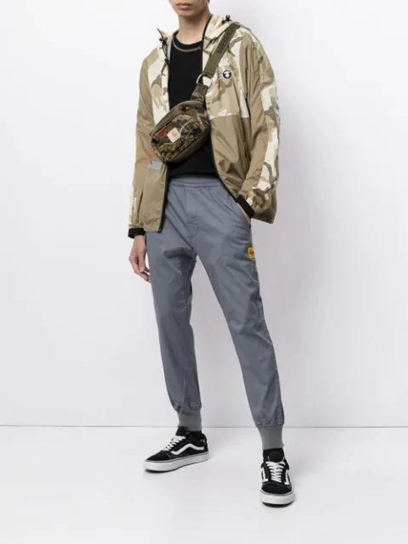 Farfetch's Post | Wearing: Vans Black And White 36 Dx Anaheim Factory Leather And Canvas Sneakers; Aape By A Bathing Ape Logo-print Track Pants In Grey; Aape By A Bathing Ape Camouflage-print Lightweight Jacket In Neutrals