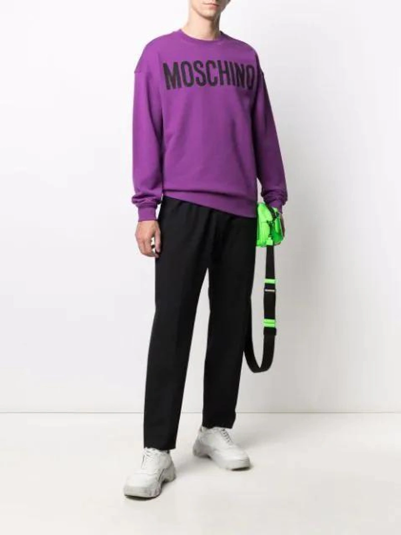 Farfetch's Post | Wearing: Emanuele Bicocchi Curb Braided Bracelet In Silver; Moschino Cotton Sweatshirt With Logo In Purple; Moschino Logo-patch Track Pants In Black