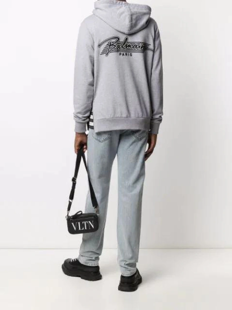 Farfetch's Post | Wearing: Valentino Garavani Small Vltn Leather Shoulder Bag In Black; Alexander Mcqueen Chunky High-top Sneakers In Black; Balmain Embroidered-logo Cotton Hoodie In Grey