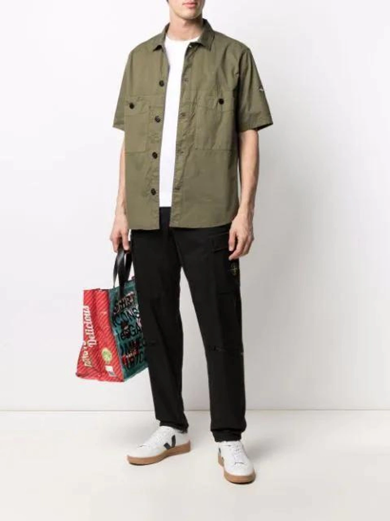 Farfetch's Post | Wearing: Our Legacy New Box Cotton Crew-neck T-shirt In White; Stone Island Logo Shortsleeve Shirt In Olive; Stone Island Logo-patch Cotton-blend Straight-leg Trousers In Black