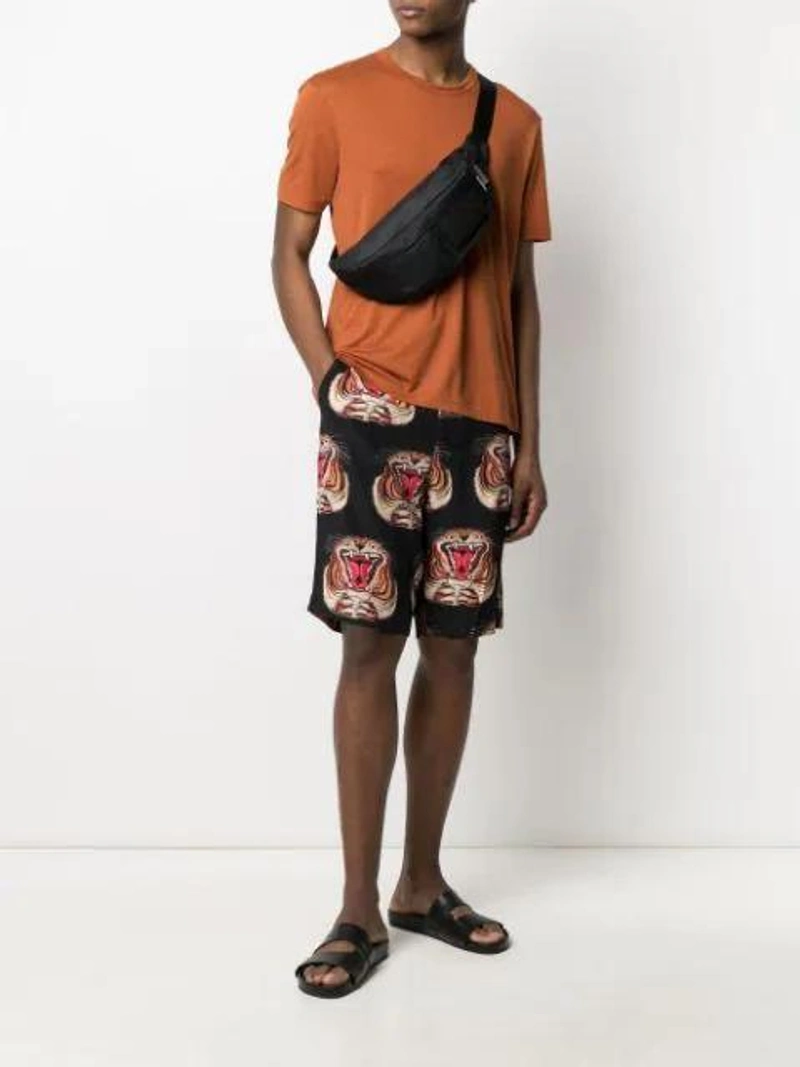 Farfetch's Post | Wearing: Endless Joy Tiger-print Knee-length Shorts In Black; Joseph Classic Crew-neck T-shirt In Orange; A-cold-wall* Logo Patch Belt Bag In Black