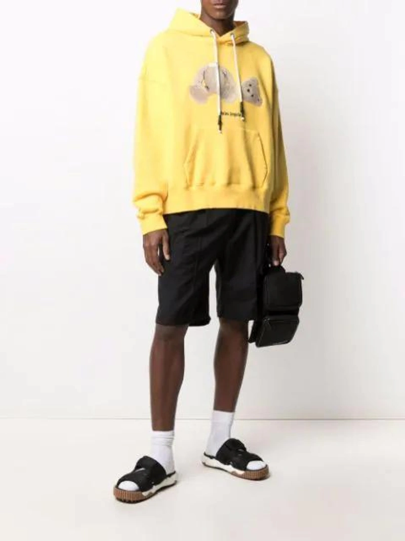 Farfetch's Post | Wearing: Palm Angels Bear Logo-print Hoodie In Yellow; Off-white Arrow Graphic Sports Socks In White; Off-white Cordura Logo Print Belt Bag In Black