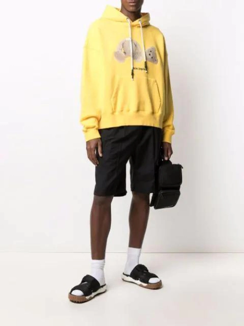 Farfetch's Post | Wearing: Palm Angels Bear Cotton Jersey Hoodie In Yellow Black; Off-white Arrow Graphic Sports Socks In White; Off-white Cordura Logo Print Belt Bag In Black