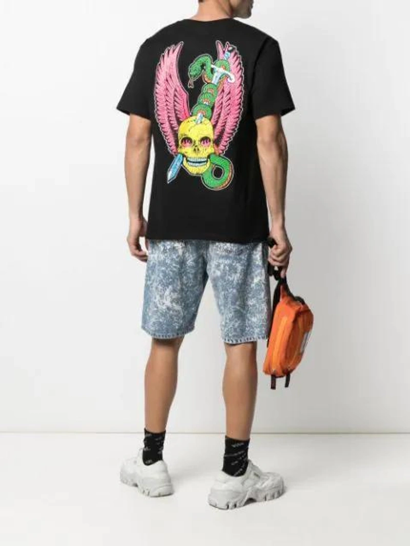 Farfetch's Post | Wearing: Stussy Printed Cotton-jersey T-shirt In Black; Msgm Slogan Intarsia-knit Socks In Black; Msgm Denim Shorts With Drawstring