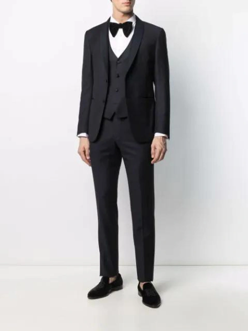 Farfetch's Post | Wearing: Corneliani Single-breasted Three-piece Dinner Suit In Blue; Comme Des Garçons Shirt Front Pocket Shirt In White; Gucci Pre-tied Cotton-blend Velvet Bow-tie In Black
