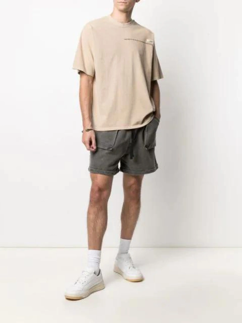 Farfetch's Post | Wearing: Val Kristopher Washed Track Shorts In Black; Val Kristopher Logo-print Short-sleeved T-shirt In Beige; Alexander Mcqueen Silver Textured Twin Skull Bracelet