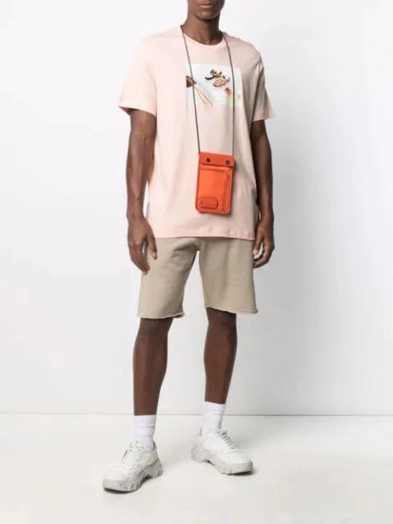 Farfetch's Post | Wearing: Nike Shoeshi Print T-shirt In Pink; Off-white X Browns 50 Caravaggio Track Shorts In Green; Jw Anderson Pulley Clutch Bag In 433 Br Orng