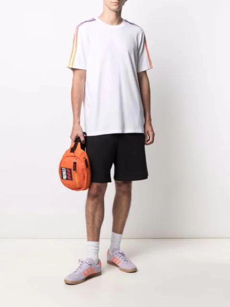 Farfetch's Post | Wearing: Adidas Originals Stripe Detail Round Neck T-shirt In White; Heron Preston Ctnb Logo Patch Belt Bag In Orange; Adidas Originals Stadt Sneakers In Purple-white