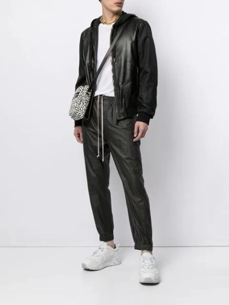 Farfetch's Post | Wearing: Dolce & Gabbana Leather Panelled Hooded Jacket In Black; Rick Owens Faux Leather Track Trousers In Black; Saint Laurent Black And White Sid Printed Messenger Bag