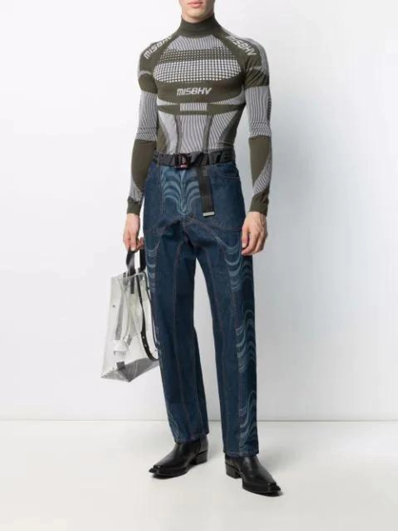 Farfetch's Post | Wearing: Misbhv Sport Active High-neck Sweater In Green; Ahluwalia Wave Effect Straight Leg Jeans In Blue; Maison Margiela Clear Logo Foldover Tote Bag In Neutrals