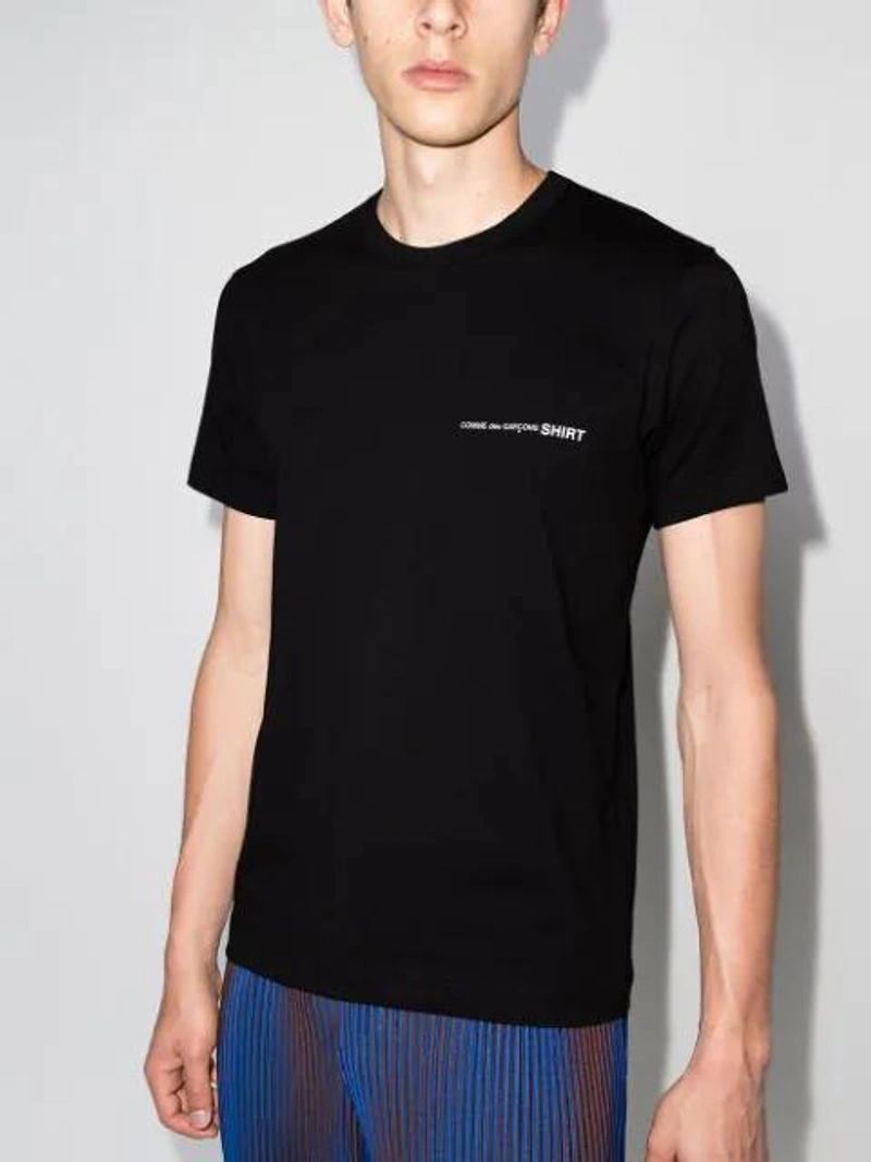Farfetch's Post | Wearing: Maison Margiela Tabi Cotton Canvas Low Top Sneakers In Black White; Comme Des Garçons Shirt Logo-print Cotton T-shirt In Black,white; Issey Miyake Hologram Striped Plissé Trousers In 75 Navy