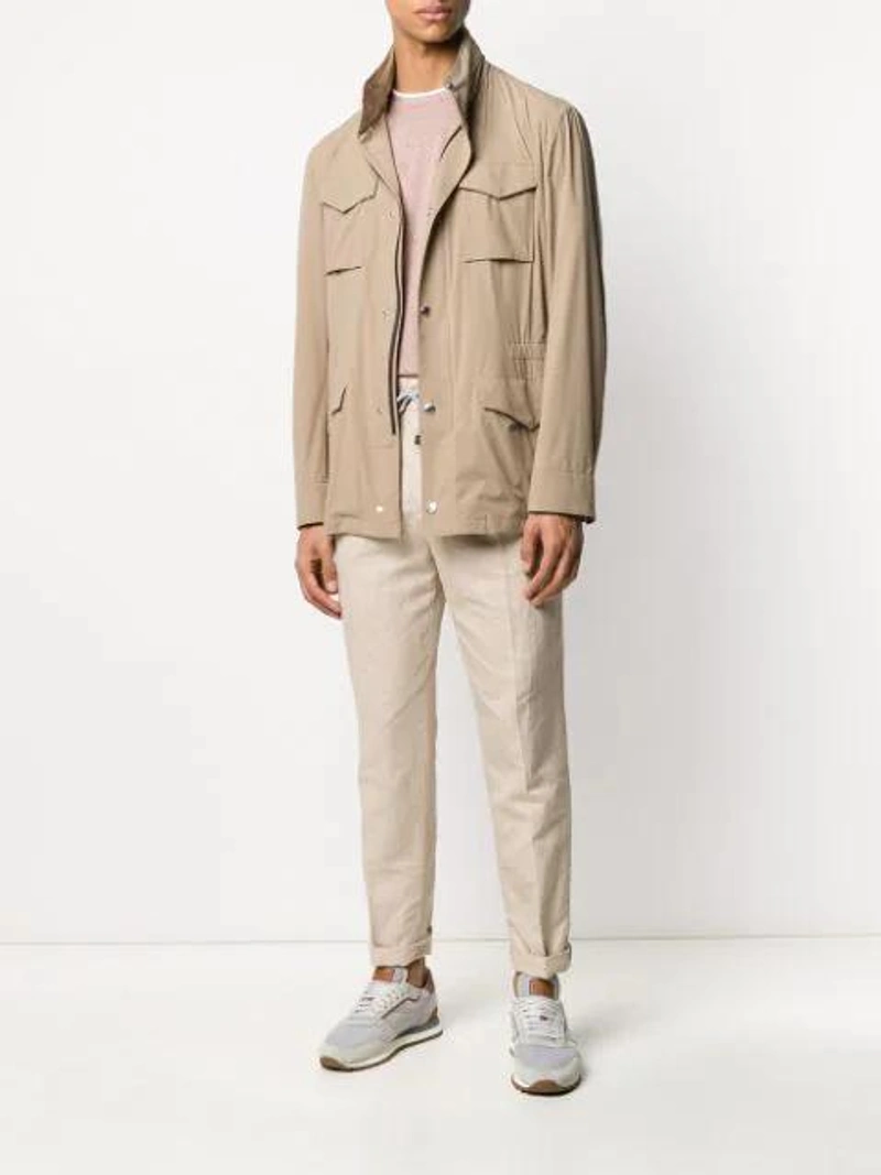 Farfetch's Post | Wearing: Brunello Cucinelli Multi-pocket High Neck Jacket In Neutrals; Brunello Cucinelli Natural Flax Chinos In Neutrals; Brunello Cucinelli Layered Effect T-shirt In Brown