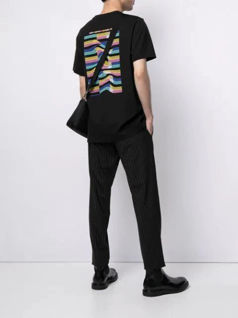 Farfetch's Post | Wearing: Alyx Black Hinged Buckle Bracelet; Fred Perry Abstract Graphic Print T-shirt In Black; Paul Smith Tapered Tailored Trousers In 79 Black