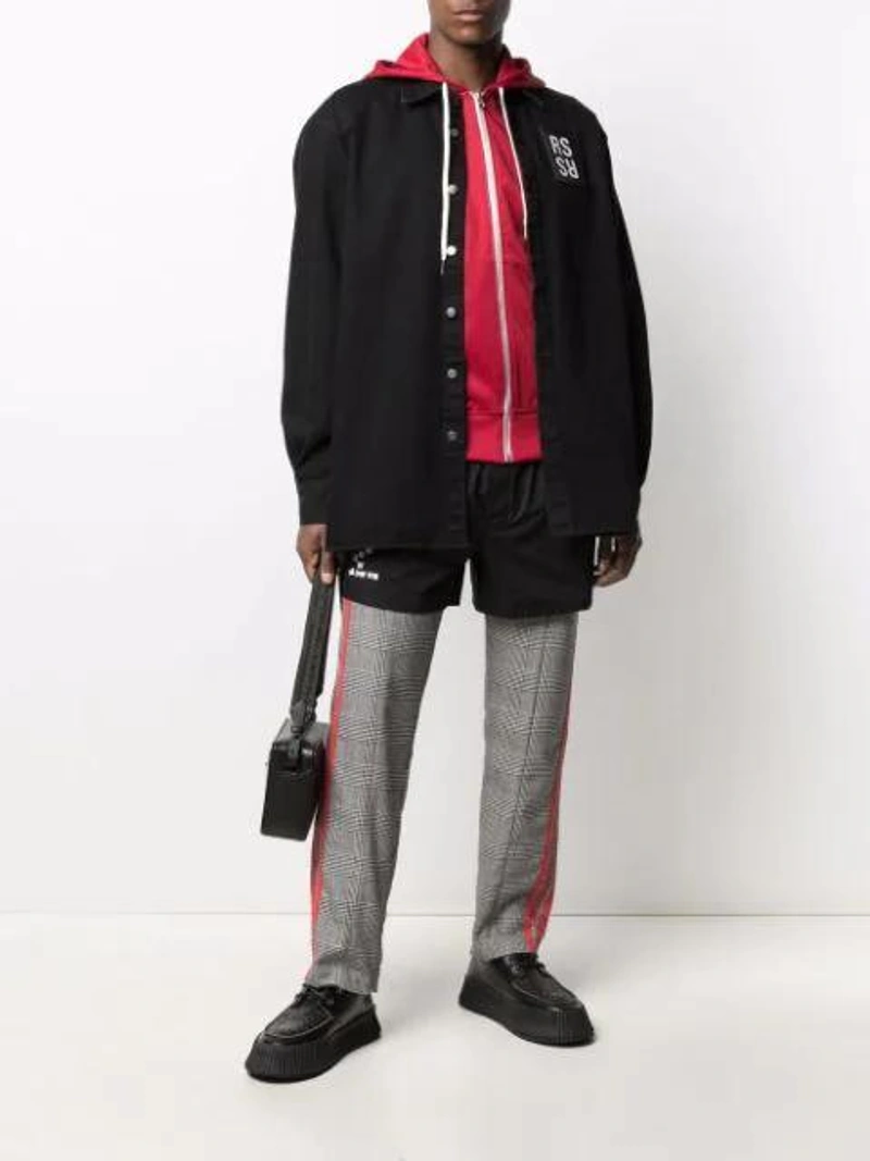 Farfetch's Post | Wearing: Raf Simons Patch-detail Track Shorts In Black; Ami Alexandre Mattiussi Side Stripe Zip-up Hoodie In Red; Raf Simons Denim Shirt With Logo Patch In Black