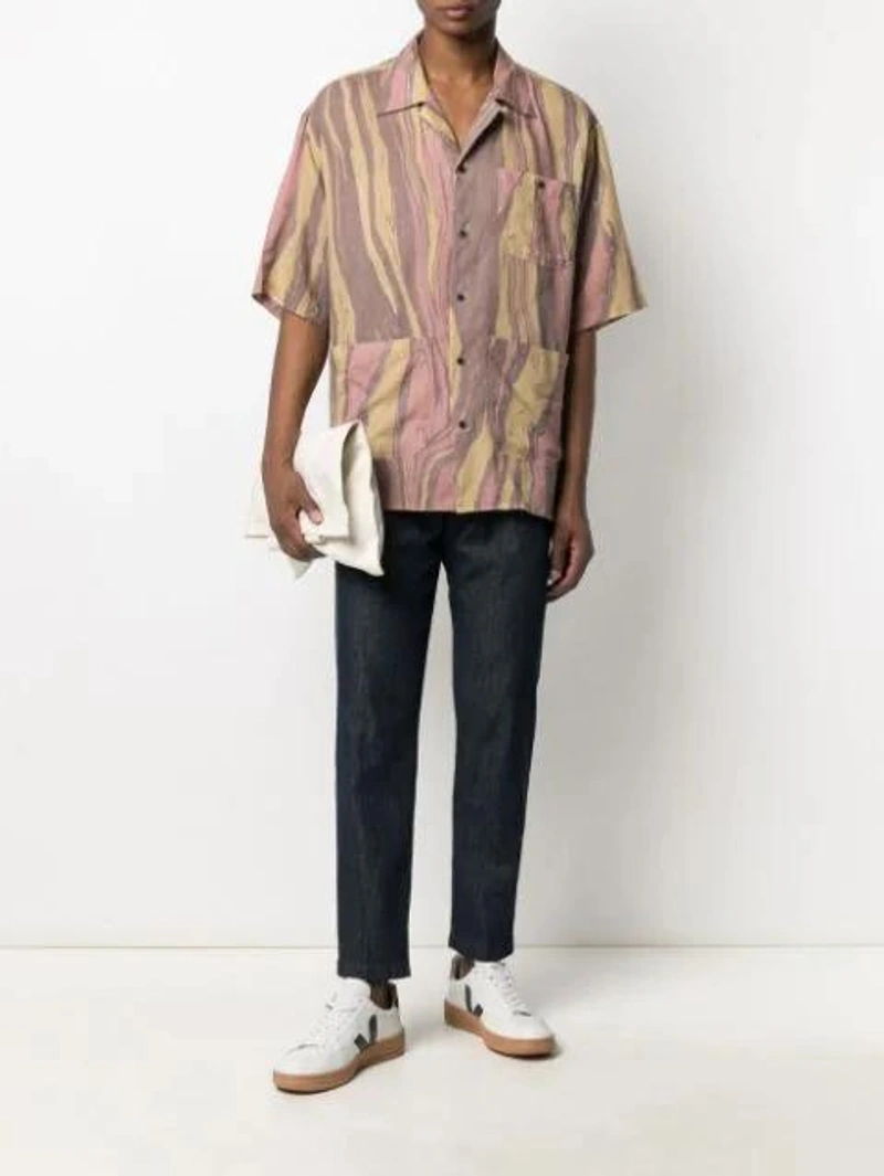 Farfetch's Post | Wearing: Emanuele Bicocchi Curb Braided Bracelet In Silver; Haikure Dark Denim Pleat Trousers In Blue; Nicholas Daley Brown Aloha Striped Short Sleeve Shirt