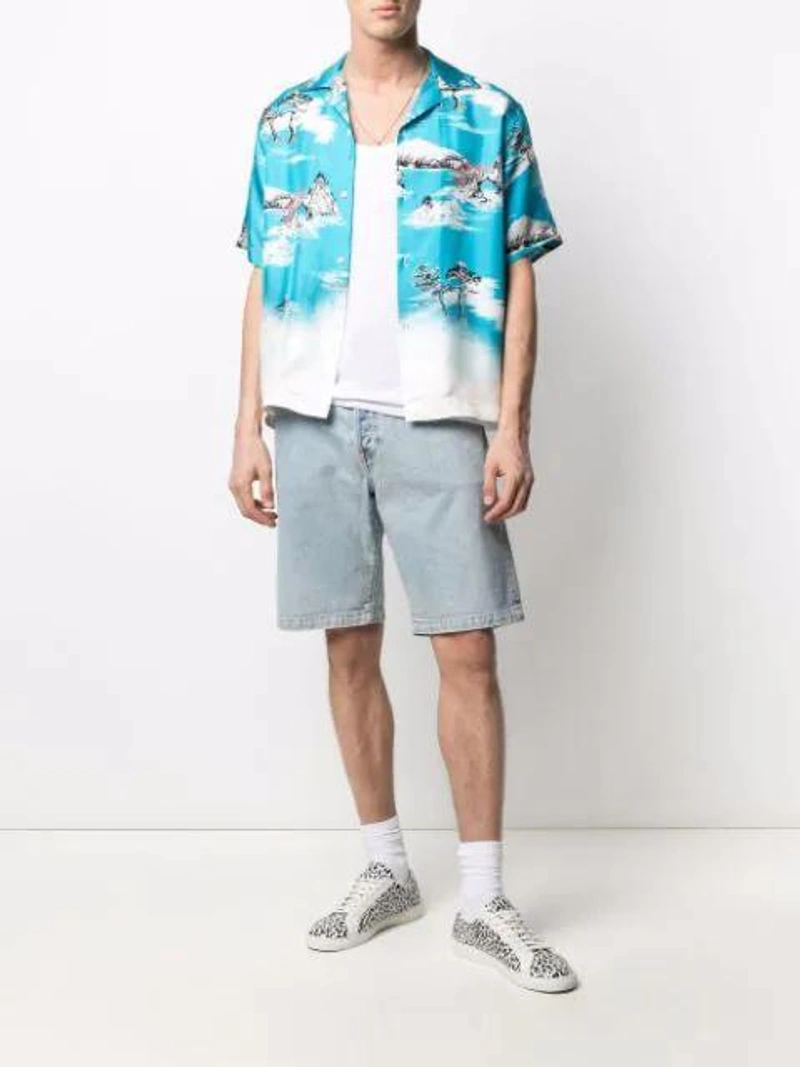 Farfetch's Post | Wearing: Emanuele Bicocchi Skull Chain Necklace In Silver; Amiri Graphic-print Short-sleeve Silk Shirt In Blue/white/red; Wardrobe.nyc X Levi's Release 04 Denim Shorts In Blue