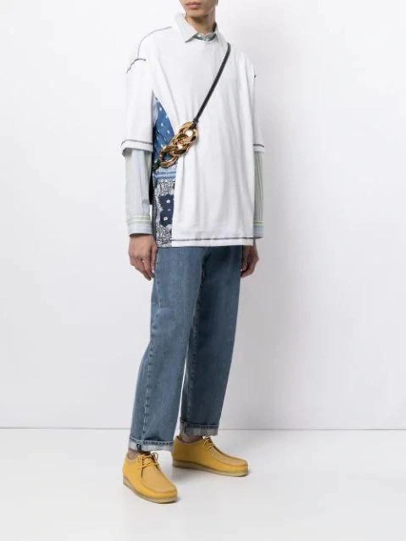 Farfetch's Post | Wearing: Five Cm Bandana-panel Cotton T-shirt In White; Sunnei Cropped Straight-leg Jeans In Washeddenim; Jw Anderson Black Nano Anchor Leather Cross Body Bag