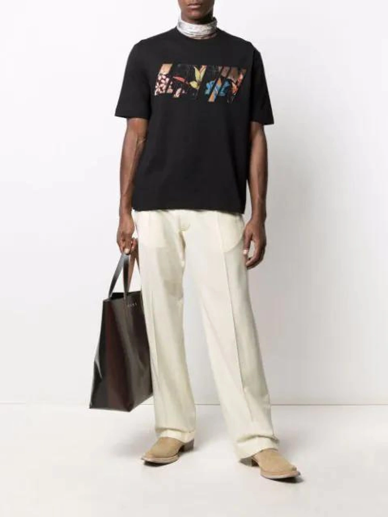 Farfetch's Post | Wearing: Lanvin Appliqué Logo Loose-fit T-shirt In Black; Maison Margiela Four-stitch Tailored Trousers In Neutrals; Acne Studios Valisa Paisley-print Silk-twill Scarf In Purple