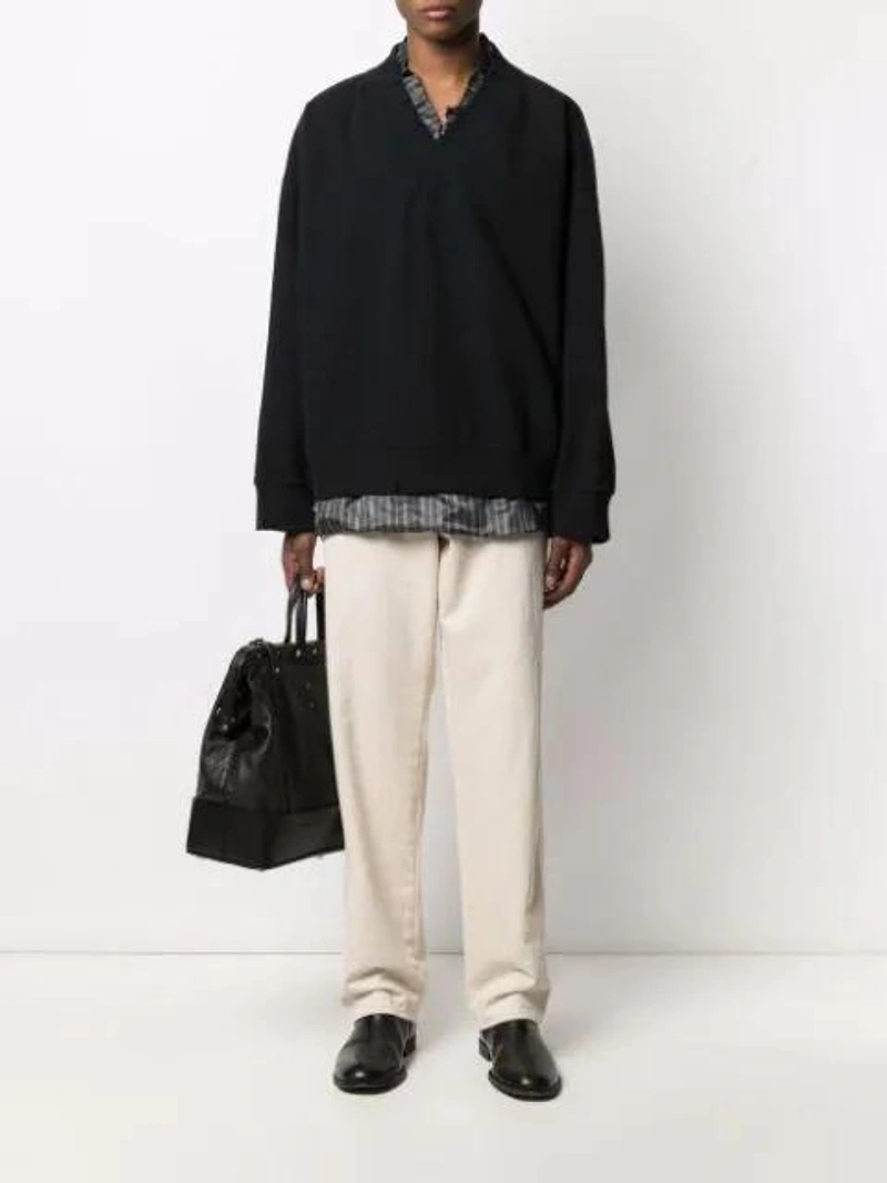 Farfetch's Post | Wearing: Maison Margiela Layered V-neck Sweatshirt In Black; Maison Margiela Four-stitch Straight-leg Jeans In Beige; Maison Margiela Belted Tote Bag In Black