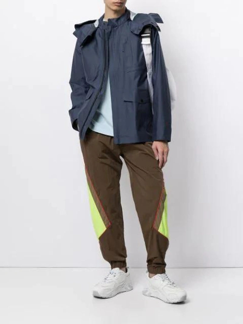 Farfetch's Post | Wearing: Stone Island Marina 3l Jacquard Jacket In Blue; Martine Rose Chuck Colour-block Track Pants In Brown; Stone Island Embroidered Logo Long-sleeved T-shirt In Blue