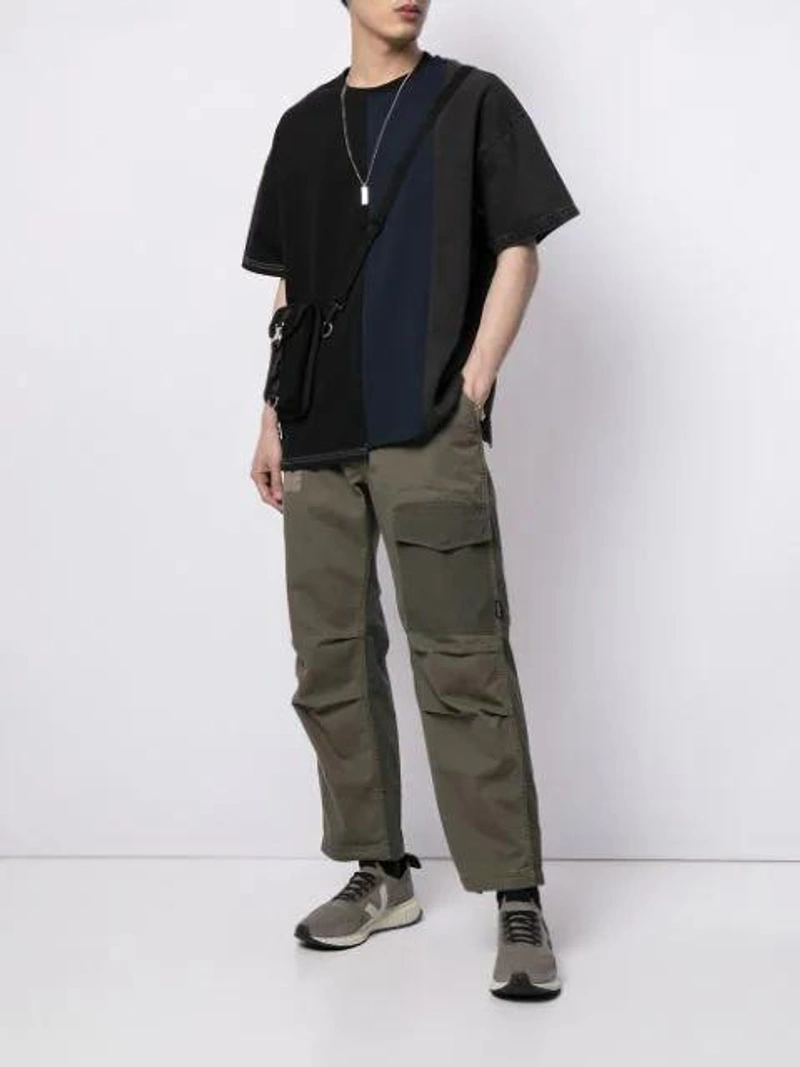 Farfetch's Post | Wearing: Five Cm Panelled Colour-block T-shirt In Black; Five Cm Colour-block Cargo Trousers In Green; Indispensable Tempo Pouch Bag In Black