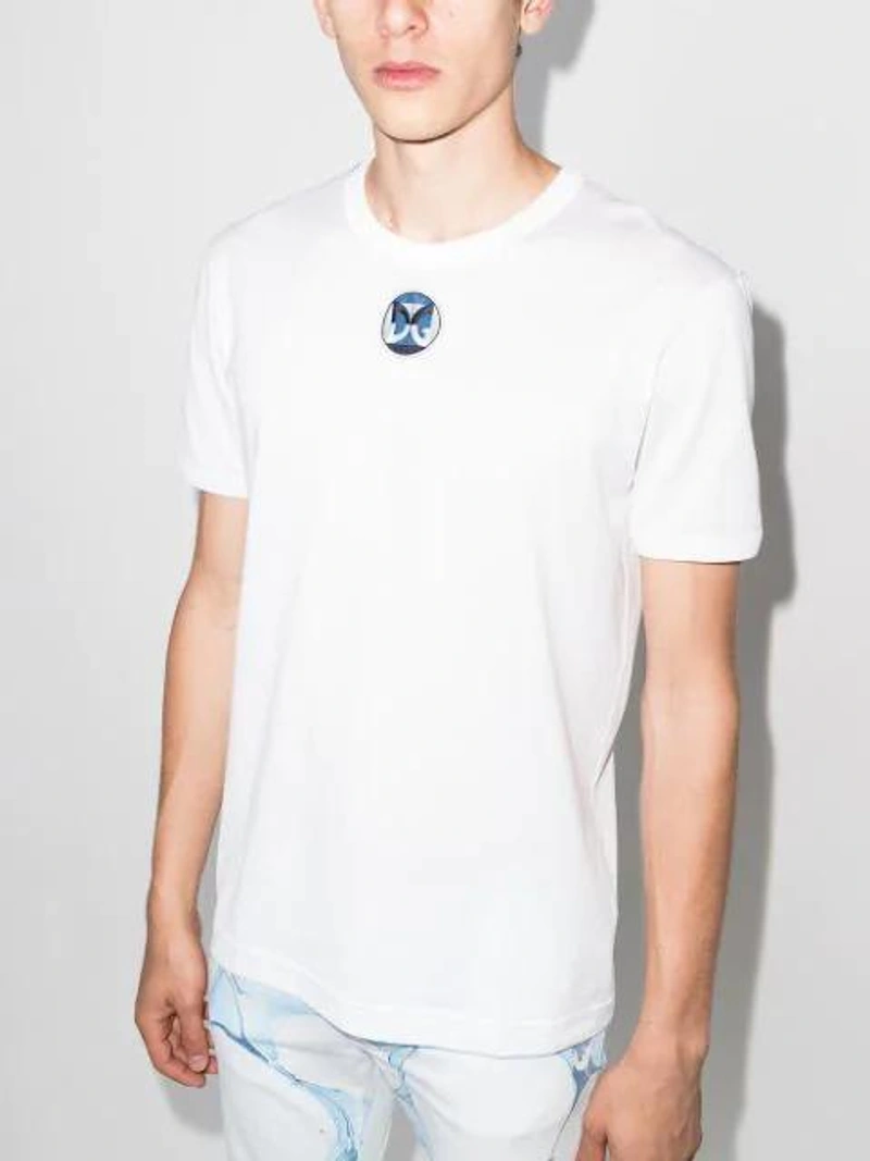 Farfetch's Post | Wearing: Dolce & Gabbana Men's Cotton Crewneck T-shirt In White; Dolce & Gabbana Brushstroke-print Slim-fit Jeans In White; Bonastre Micro Leather Ring Cross-body Bag In Black