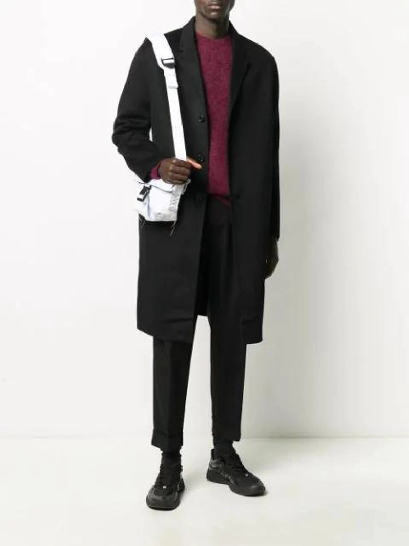 Farfetch's Post | Wearing: Acne Studios Pleated Twill Chinos In Black; Acne Studios Double-faced Single-breasted Coat In Double-faced Wool Coat; Acne Studios Raw Edged Shoulder Bag In White