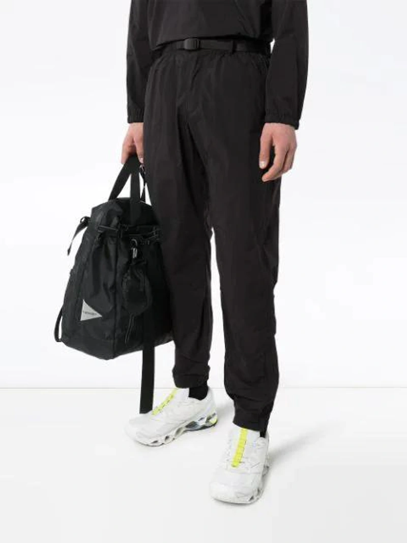 Farfetch's Post | Wearing: Gramicci Buckled Cotton-twill Trousers In Black; Gramicci Black Camp Packable Shell Anorak; Gramicci Mantel Mit Grossen Blenden In Black