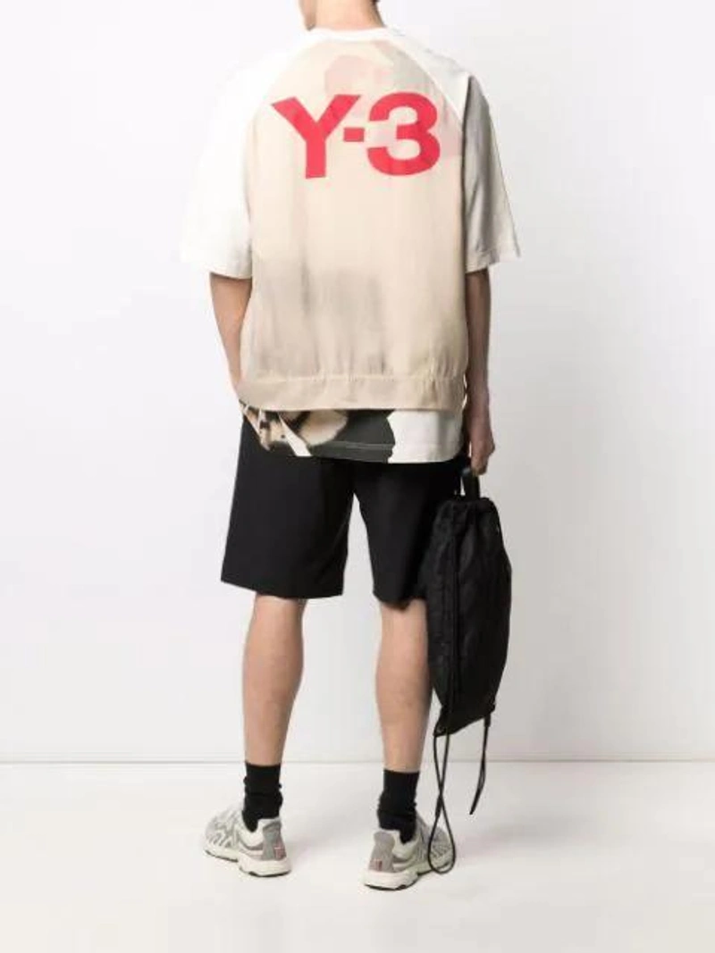 Farfetch's Post | Wearing: Y-3 Beige Raw Jersey Graphic Floral T-shirt In Neutrals; Y-3 Black Classic Logo Shorts; Maison Margiela Four-stitch Drawstring Backpack In Black