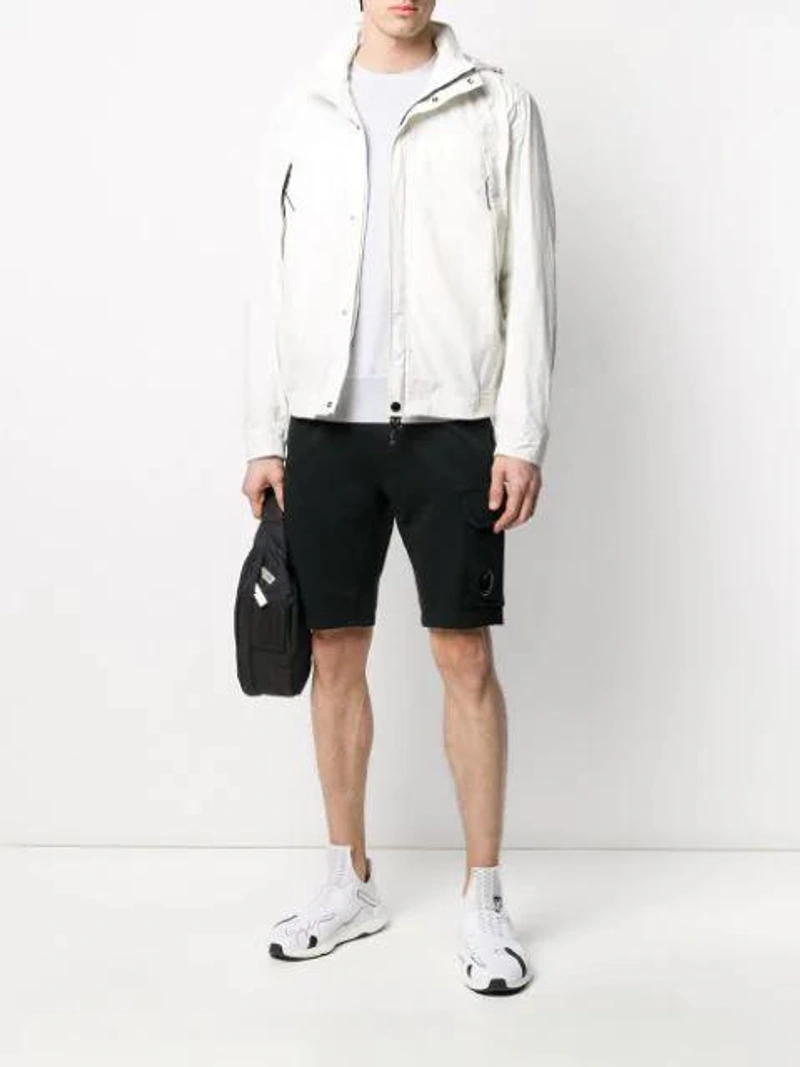 Farfetch's Post | Wearing: C.p. Company Stitched Panel Jumper In Grey; C.p. Company Shorts Mit Kordelzug In Black; C.p. Company Zipped Lightweight Jacket In White