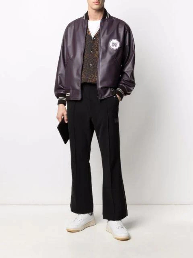 Farfetch's Post | Wearing: Emanuele Bicocchi Skull Chain Necklace In Silver; Needles Mid-rise Flared Cropped Trousers In Black; Needles Logo-patch Bomber Jacket In Purple