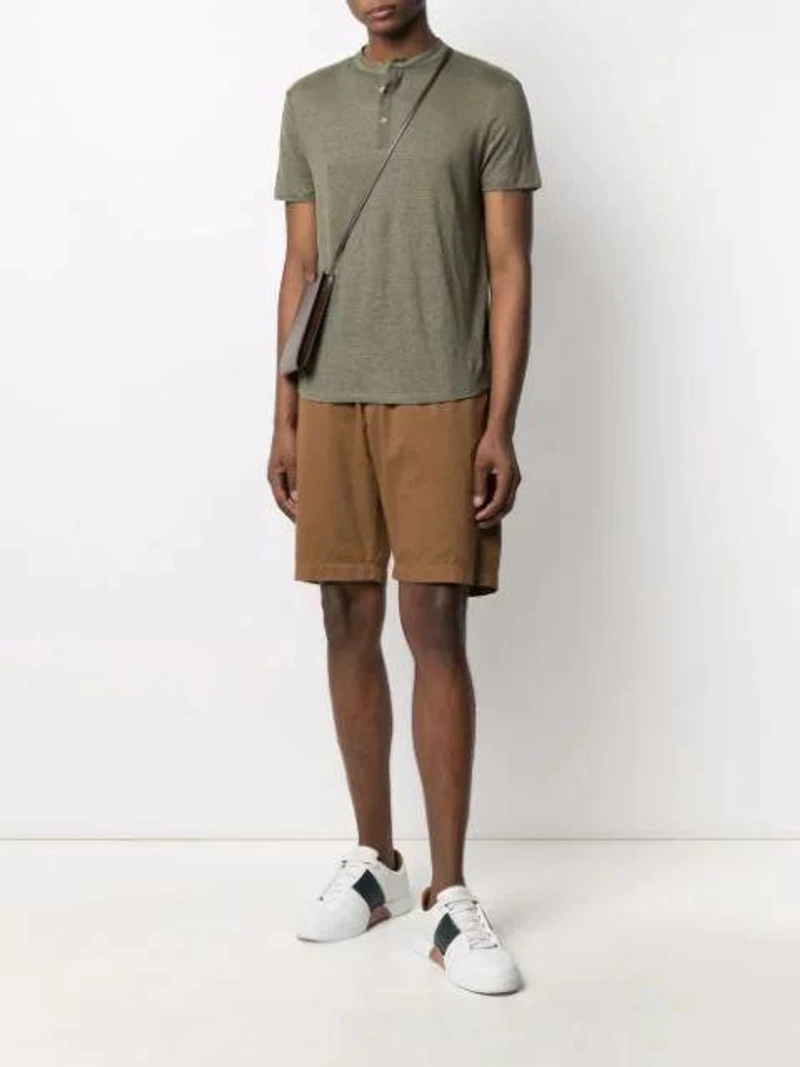 Farfetch's Post | Wearing: Majestic Crew-neck Fitted T-shirt In Green; Sunspel Elasticated Cotton Shorts In Brown; Apc Logo-print Leather Messenger Bag In Brown