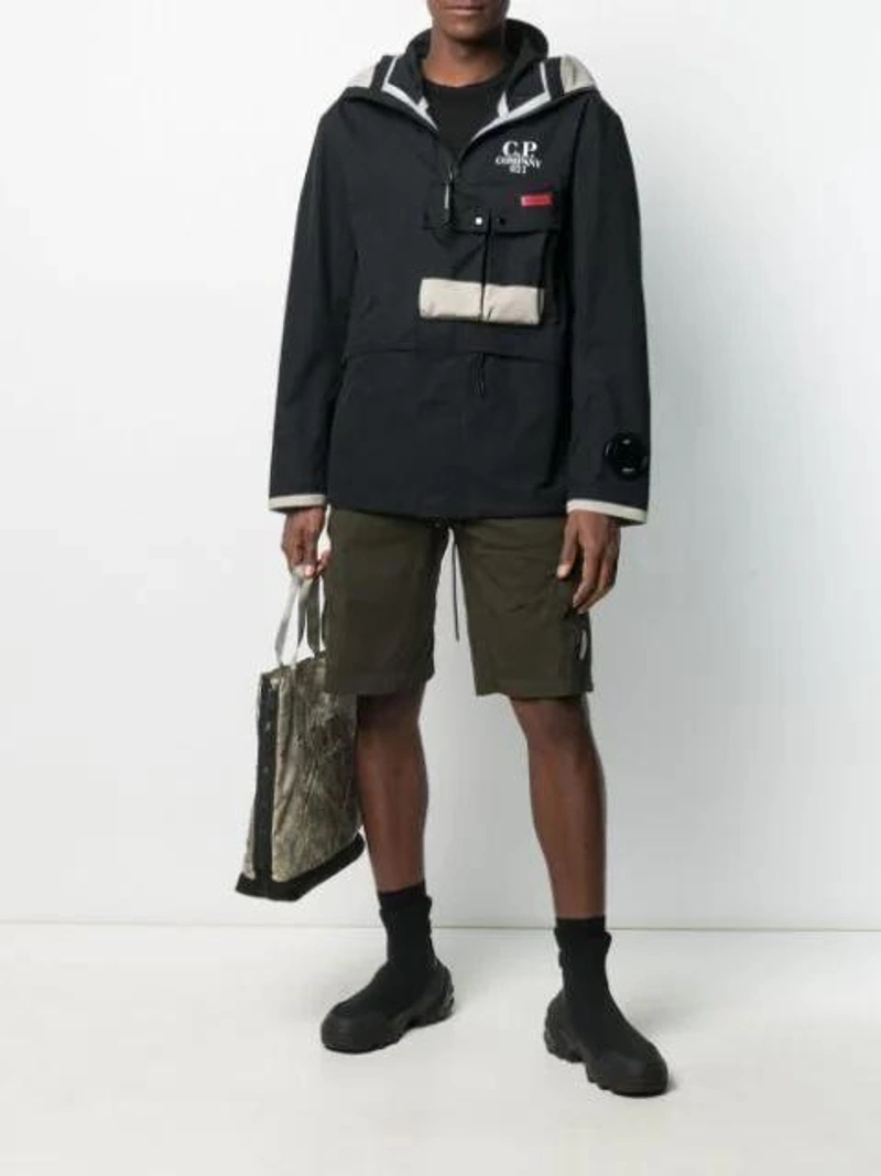 Farfetch's Post | Wearing: C.p. Company Lens-detail Cargo Shorts In Green; Stone Island 'burnout' Shopper In Green; Alyx Sock-style Knit Ankle Boots In Black