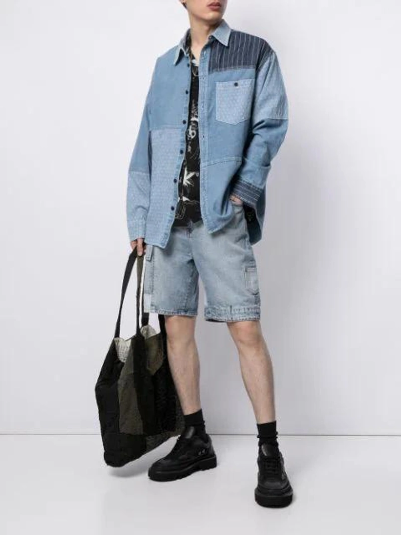 Farfetch's Post | Wearing: Five Cm Patchwork Denim Shirt In Blau; Five Cm Patchwork Denim Shorts In Blue; Five Cm Graffiti Print Shirt In Black