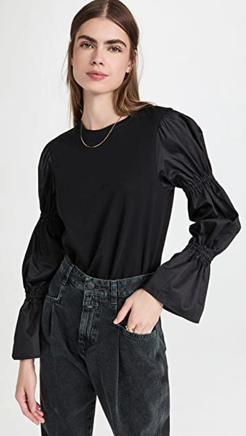 shopbop.com's Posts | Wearing: Something Navy Cinched Bell Sleeve Top In Black; Closed Pearl Jeans In Grey; Shashi Remix Ring Set