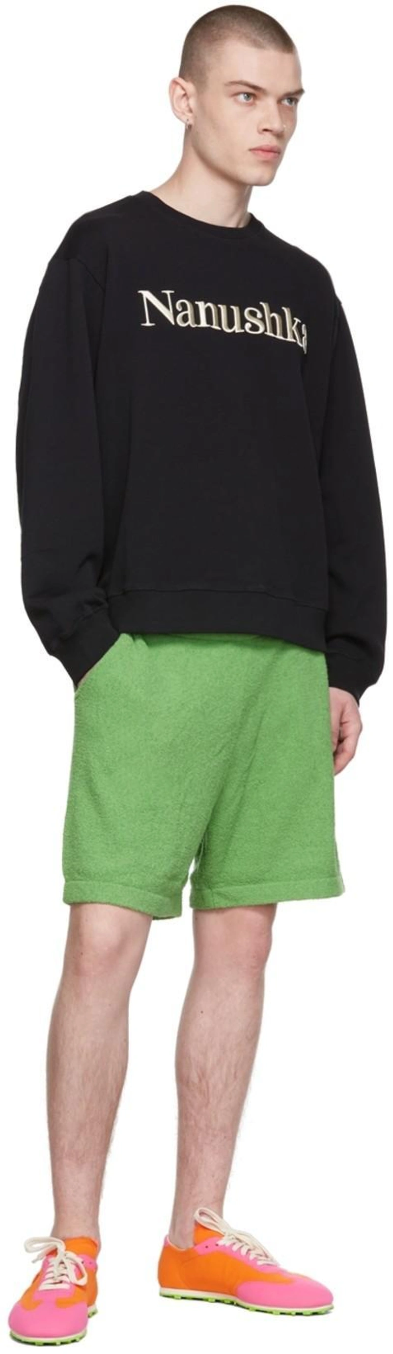 SSENSE's Post | 搭配: Nanushka Remy Logo-embroidered Organic-cotton Sweatshirt In Black；Nanushka Green Brent Shorts；Marni Pink & Orange Pebble Sneakers In Zo091 Light Orange+f