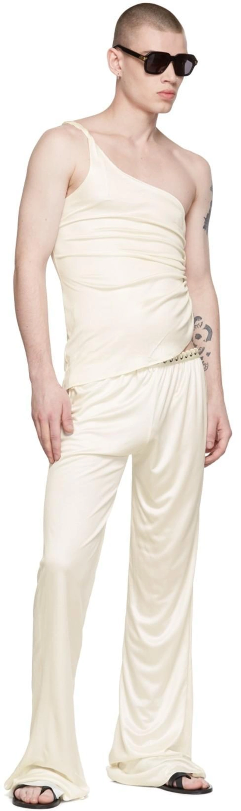 SSENSE's Post | 搭配: Saint Laurent Men's Culver Mules In Smooth Leather In 1000 Nero；Ludovic De Saint Sernin White Mermaid Trousers；Ludovic De Saint Sernin One-shoulder Asymmetrical Top In White