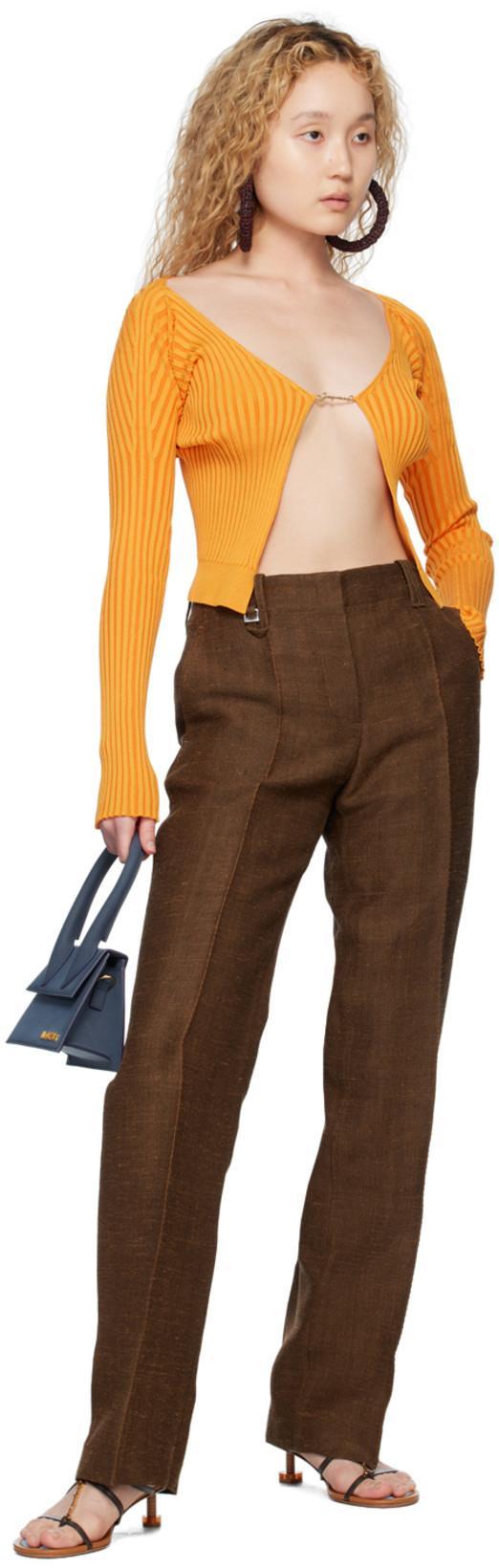 JACQUEMUS ‘pralu' Gold Toned Logo Charm Long Sleeve Cropped Cardigan In Orange